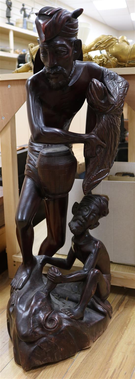 A large South East Asian hardwood carving of fishermen, height 92cm